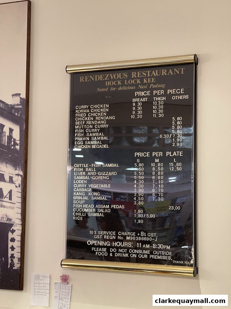 A menu board for Rendezvous Restaurant Hock Lock Kee, featuring Nasi Padang dishes and prices.