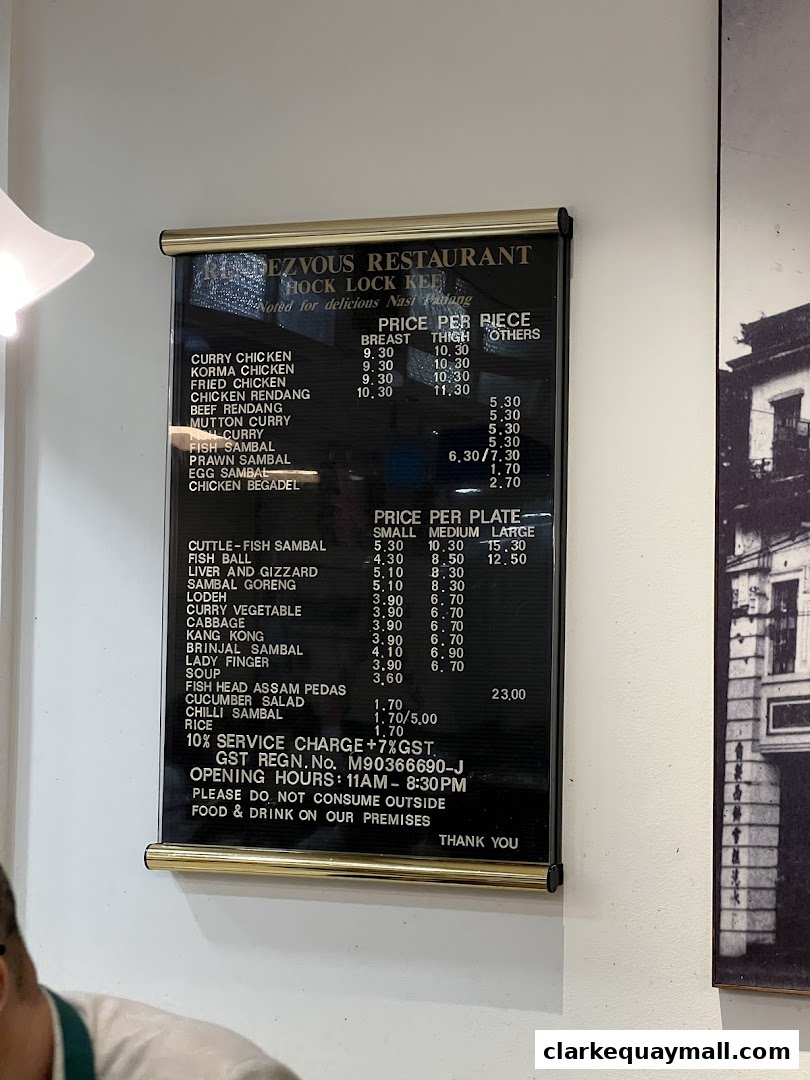 A menu board for Rendezvous Restaurant Hock Lock Kee, featuring Nasi Padang dishes and prices.
