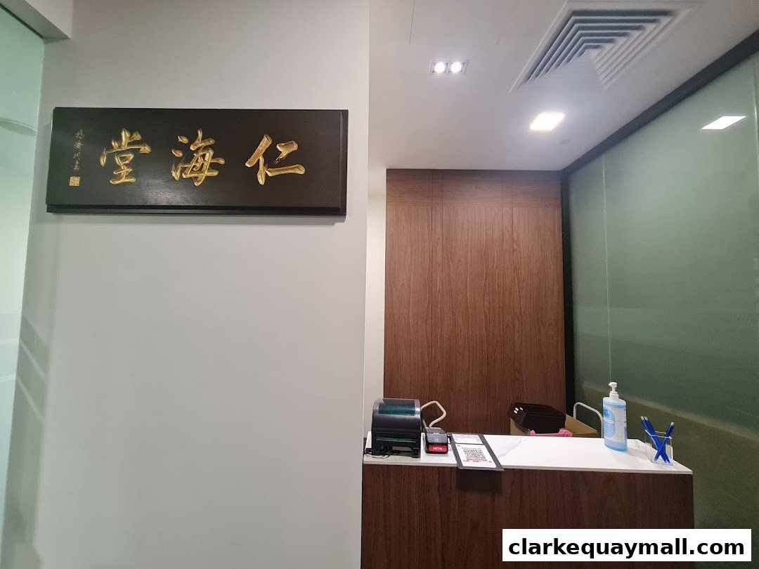 Interior shot of Renhai Clinic Clarke Quay with a reception desk and signage.