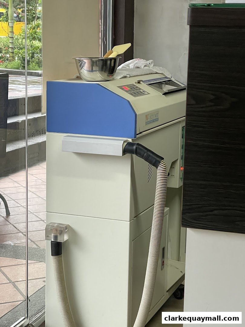 A medical or aesthetic treatment machine with hoses and a metal bowl on top.