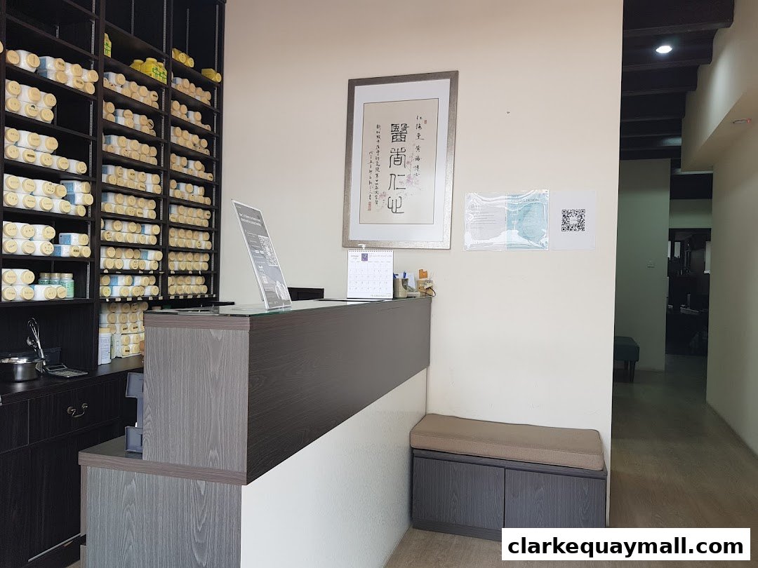 Interior of a clinic reception area with shelves of products and a waiting bench.