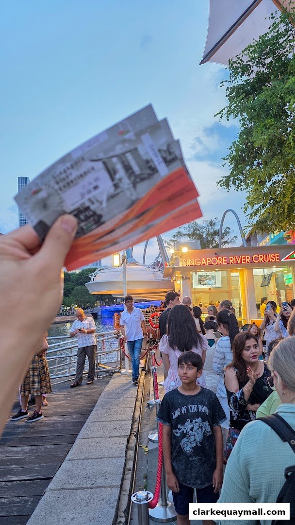 People queuing for Singapore River Cruise tickets at dusk.