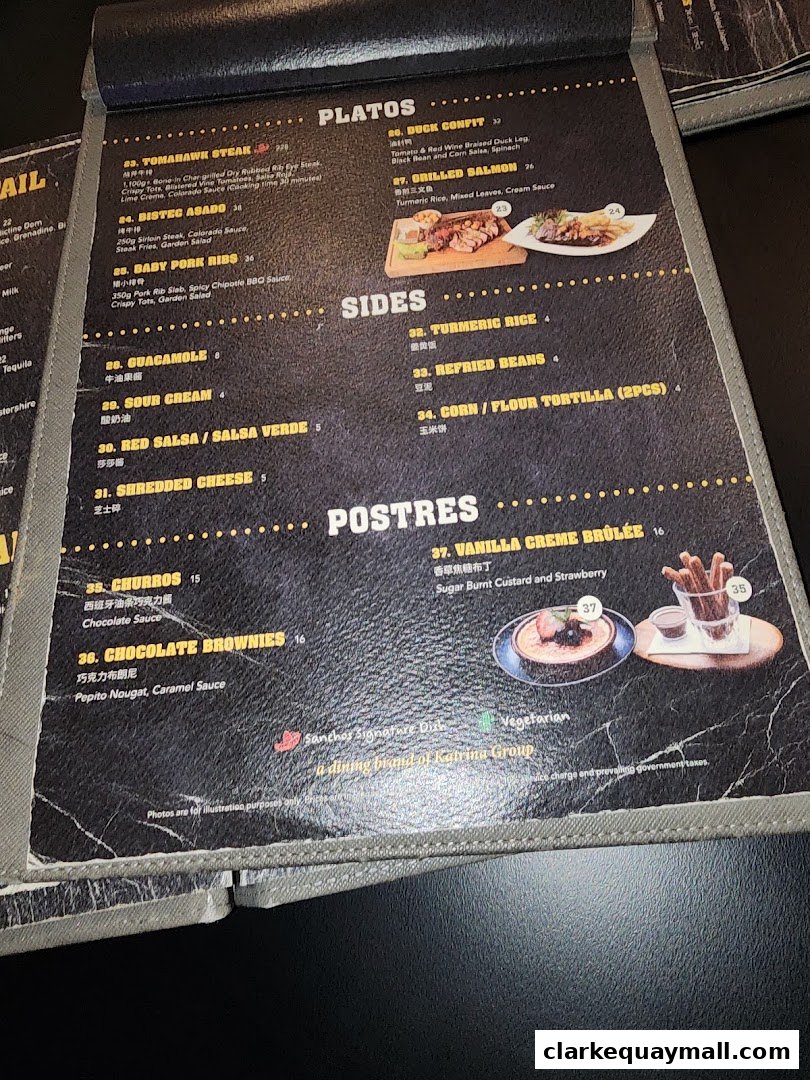 A menu featuring dishes like Tomahawk Steak, Duck Confit, Grilled Salmon, Churros, and Chocolate Brownies.