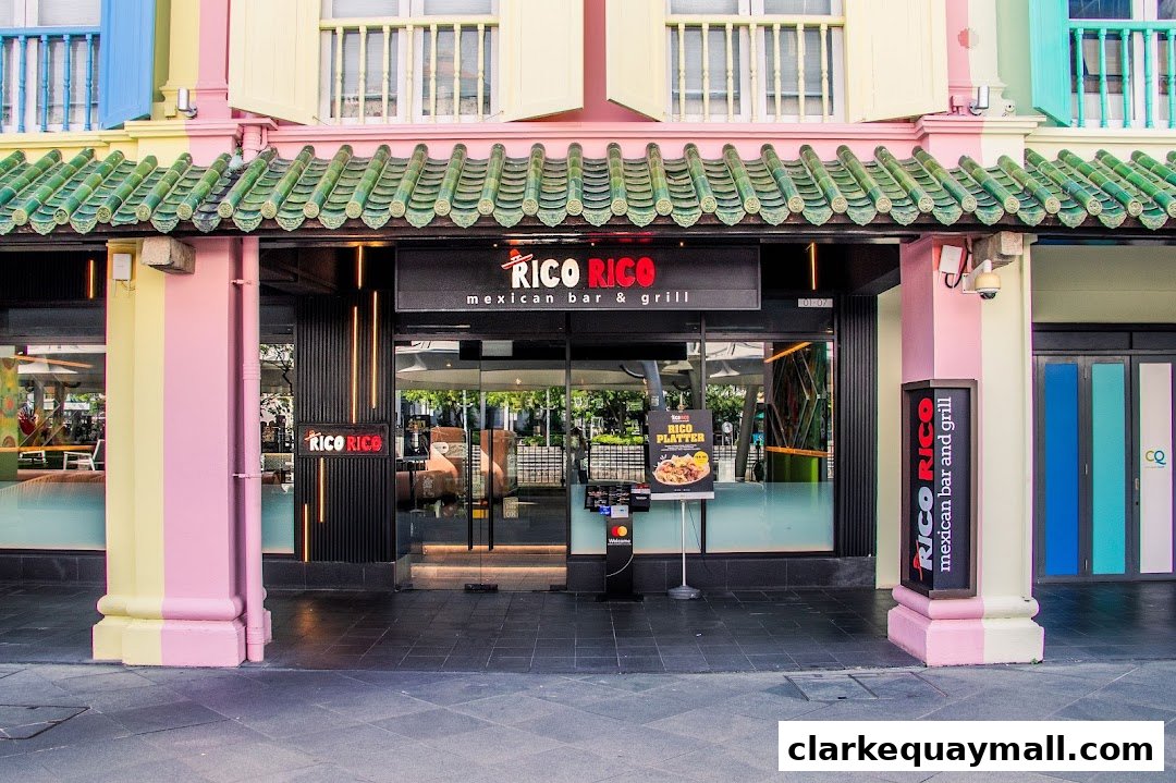The exterior of Rico Rico, a Mexican bar and grill, with colorful pillars and a green tiled roof.