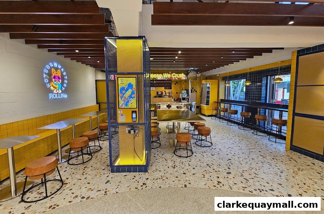 Interior of a brightly lit, modern eatery with yellow accents and seating.