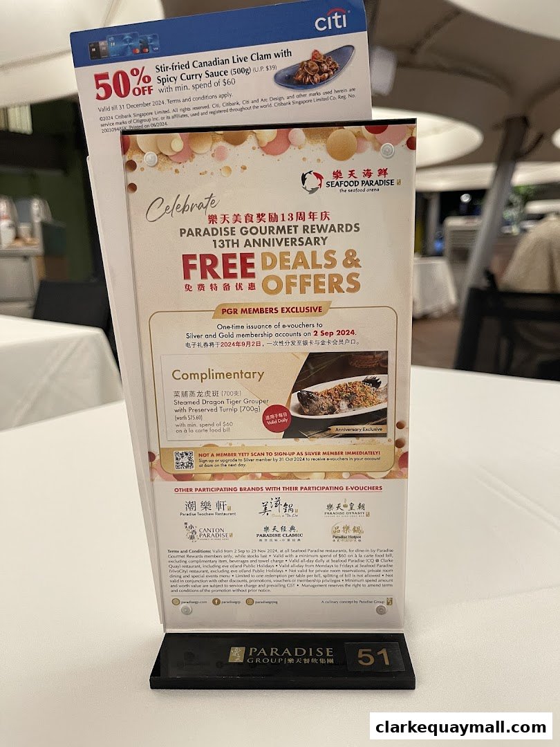 A promotional table tent for Seafood Paradise celebrating its 13th anniversary with free deals and offers.