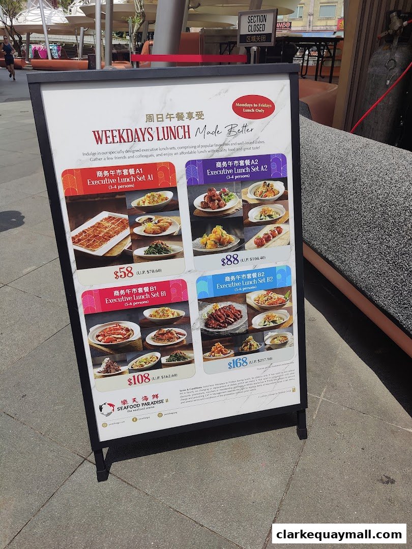 A sign advertising weekday lunch sets from Seafood Paradise with prices and images of food.