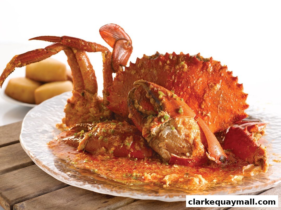 A delicious plate of chili crab with steamed buns on the side.
