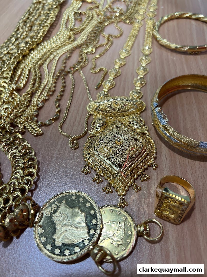 A collection of exquisite gold jewelry, including necklaces, bracelets, rings, and coins.