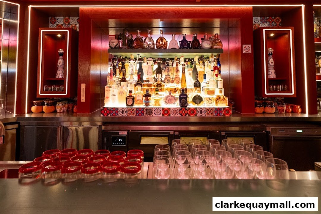 A well-stocked bar with numerous bottles of liquor and rows of clean glasses.