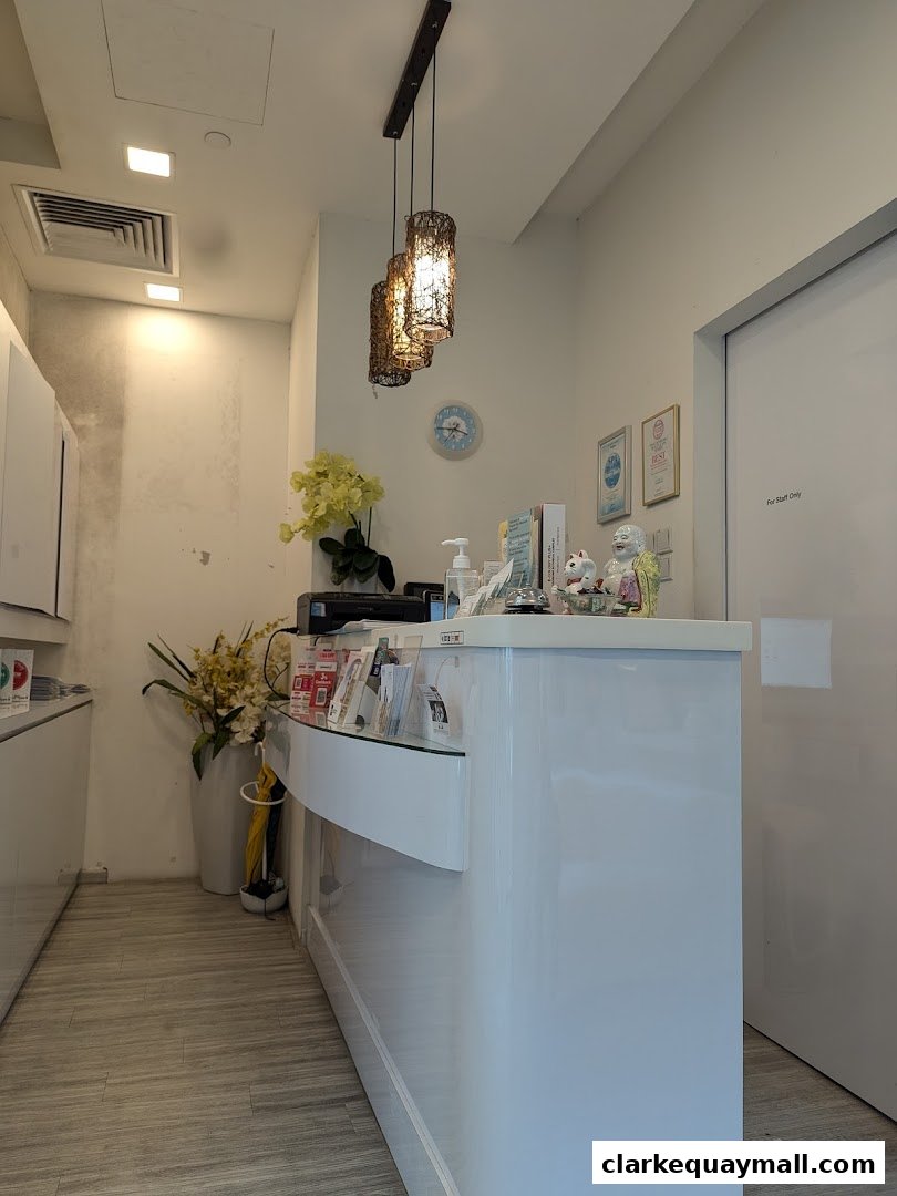 The reception area of a hair removal salon with a white counter and decorative lighting.