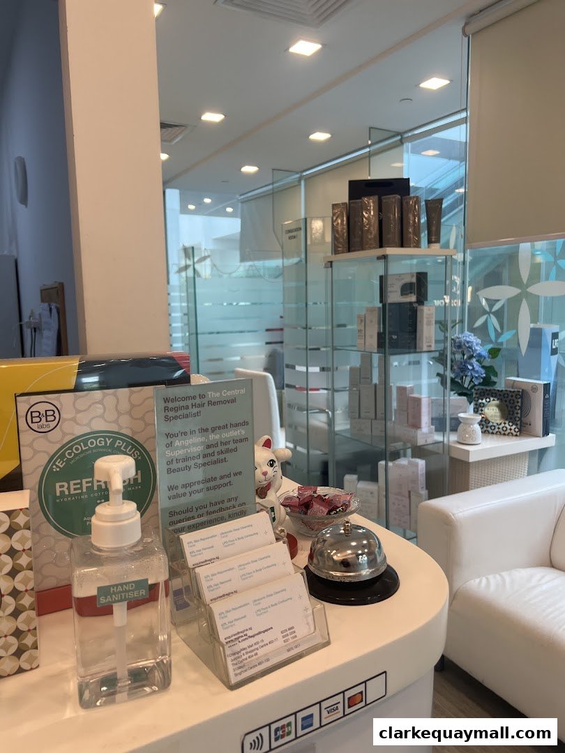 Reception desk area of a hair removal specialist shop with hand sanitizer and business cards.