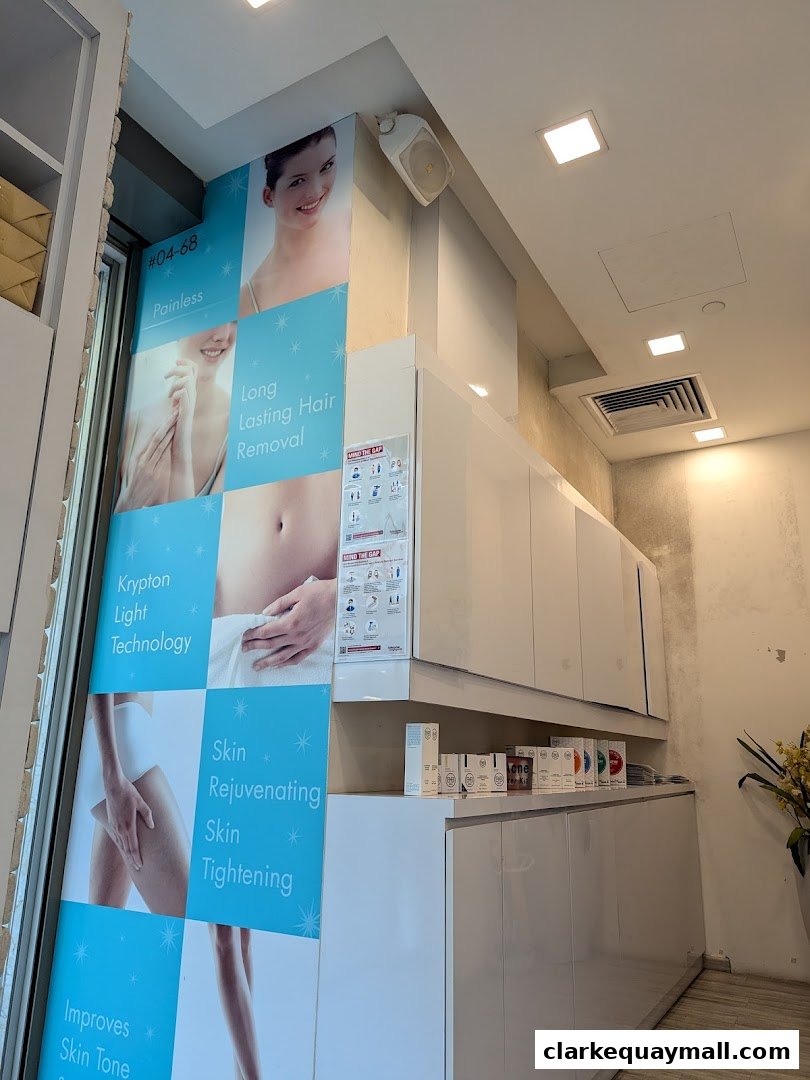 Interior of a hair removal salon with promotional posters and white cabinets.