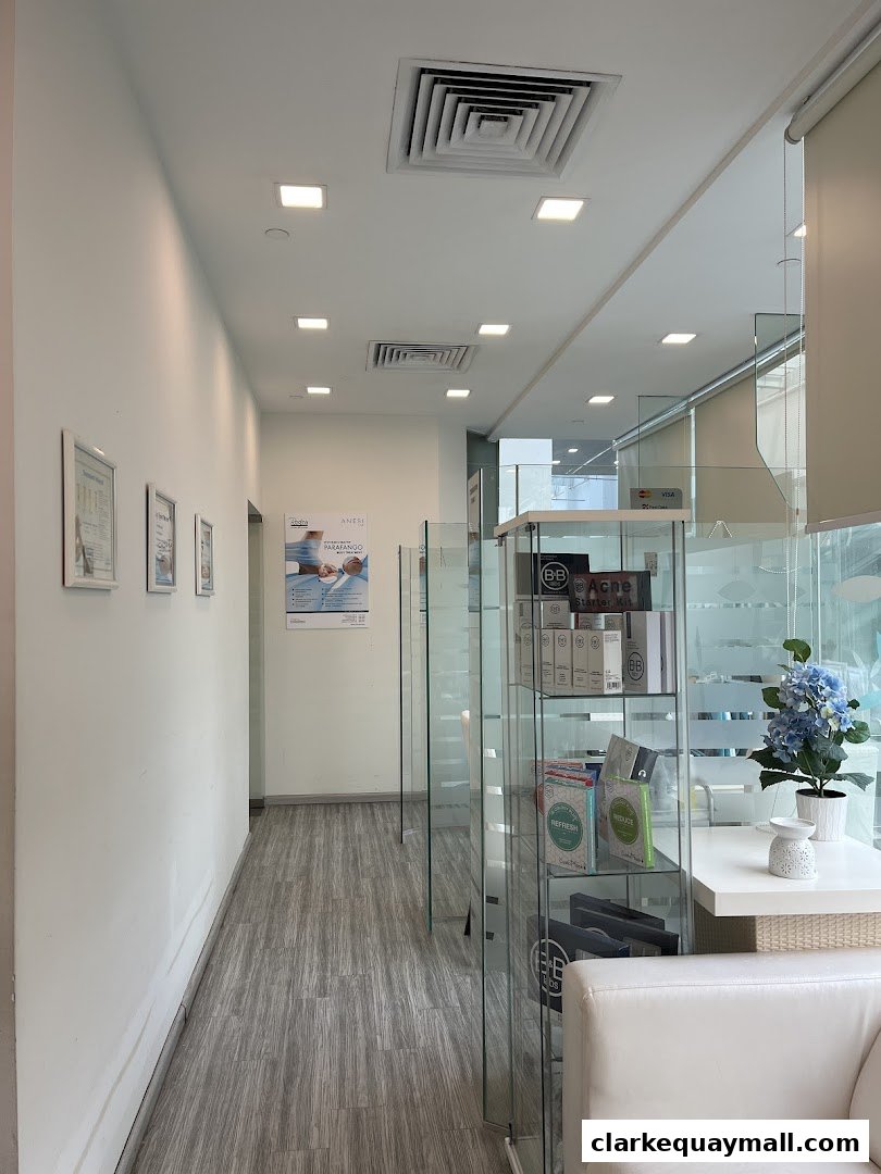 Interior view of a modern hair removal salon with glass displays and white seating.