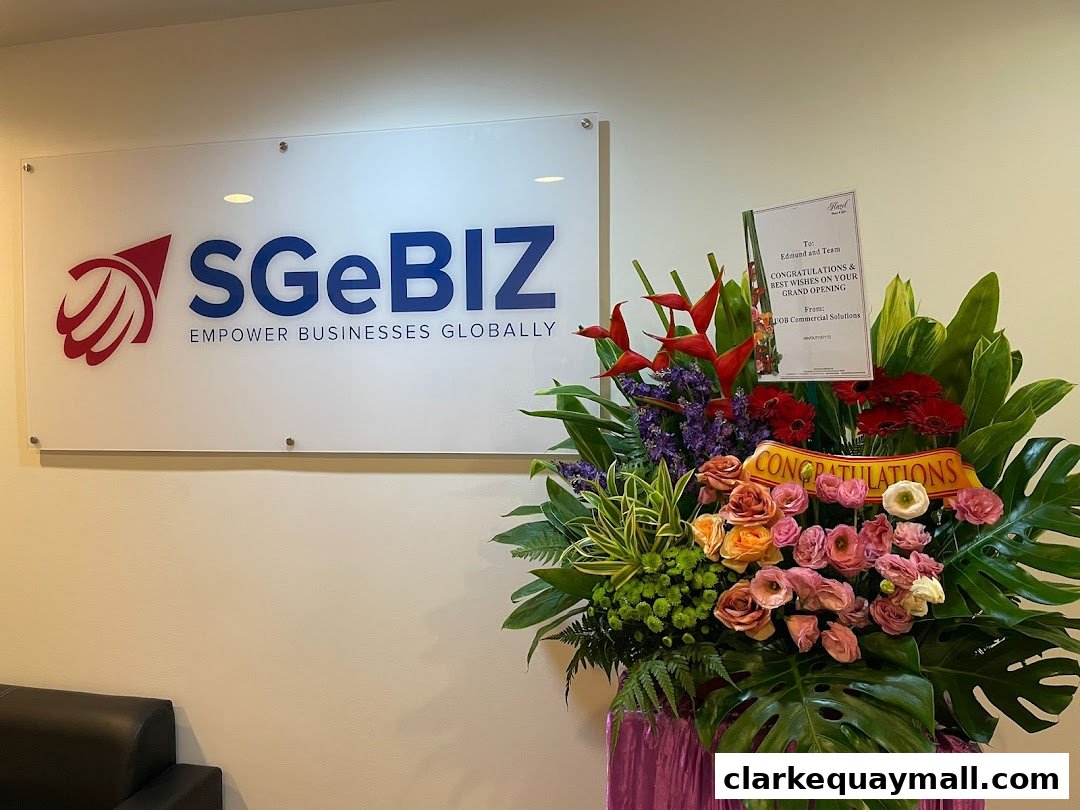 The SGeBIZ logo and a congratulatory flower arrangement for a grand opening.