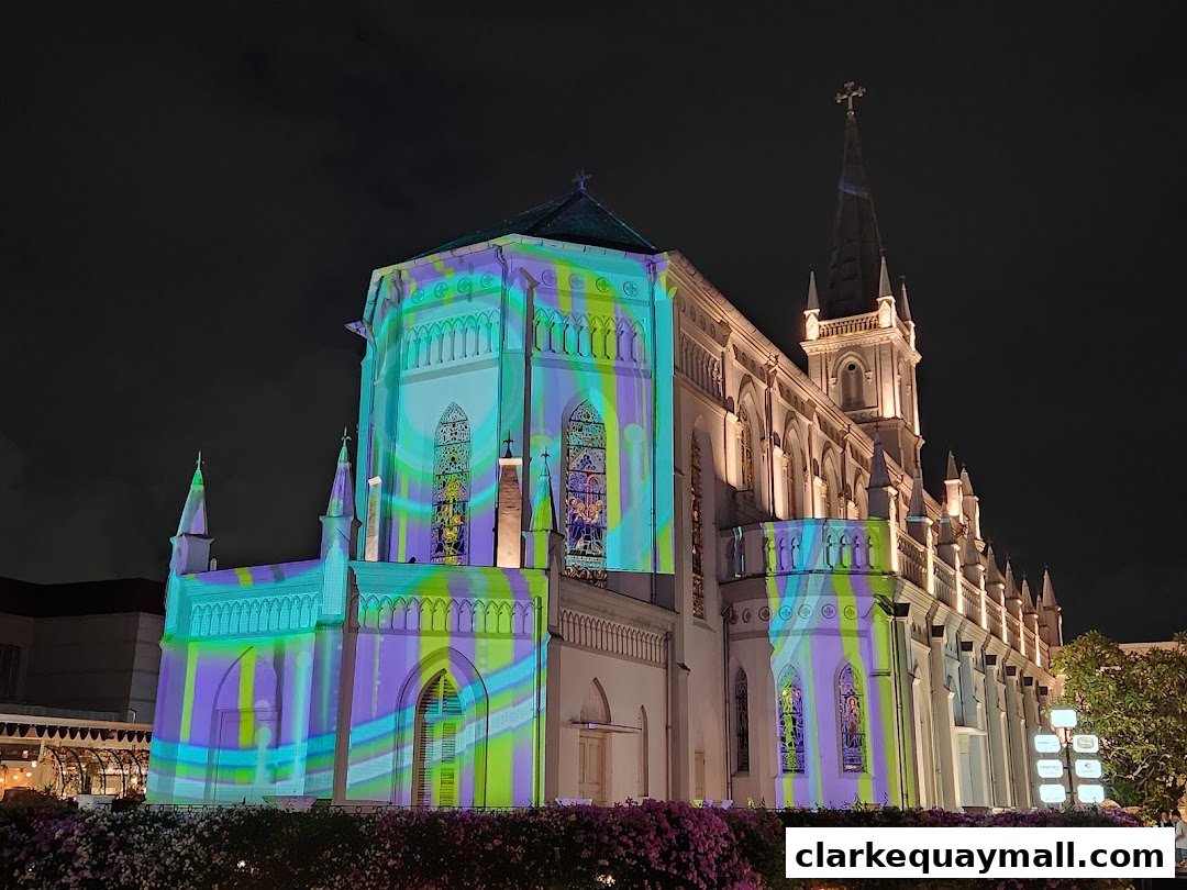 A grand building illuminated with colorful light projections at night.
