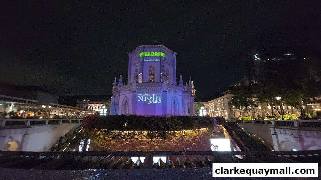 A building illuminated with 'Welcome' and 'Singapore Night Festival' projections at night.