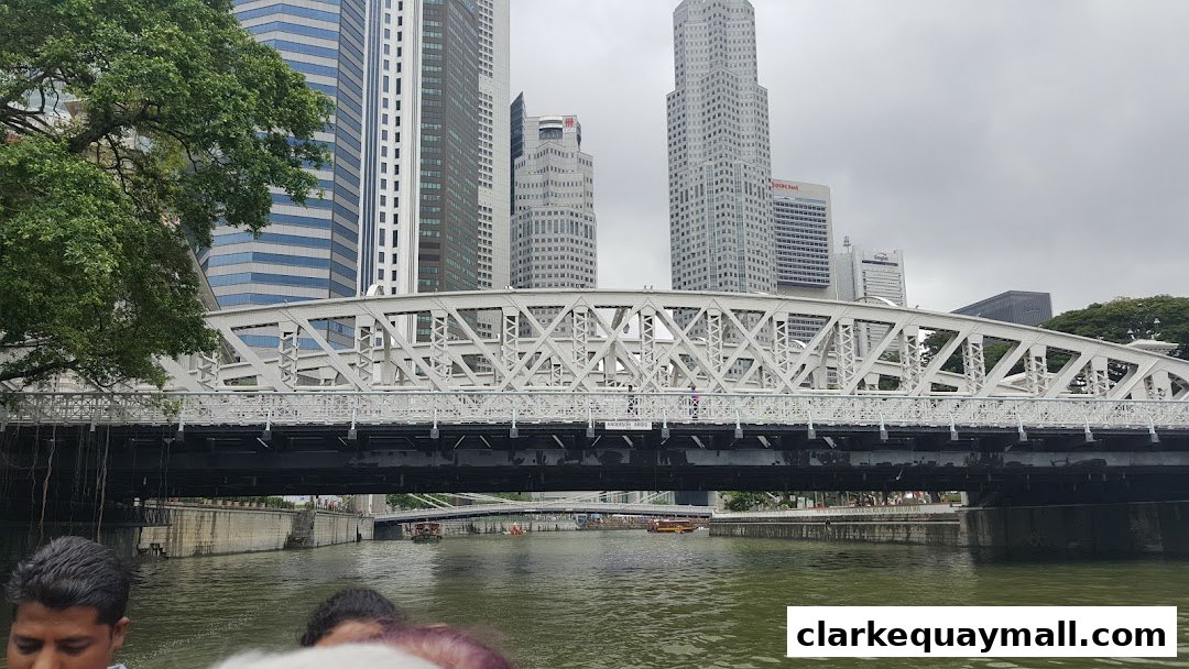 A view of the Singapore River with a bridge and city skyline in the background.