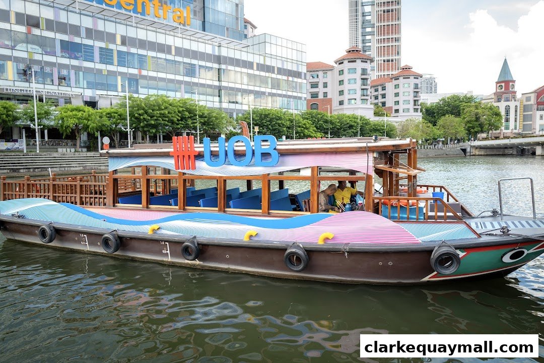 A boat with UOB branding on the Singapore River with buildings in the background.