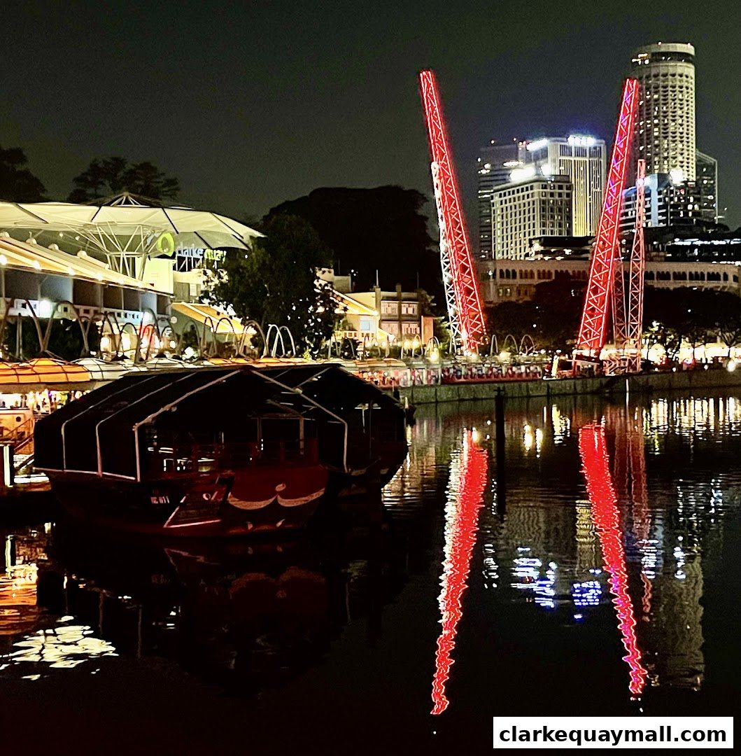Night view of a waterfront with boats and a large red slingshot ride.