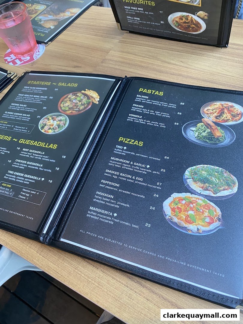 A menu open to a page with pastas, pizzas, starters, salads, and quesadillas.