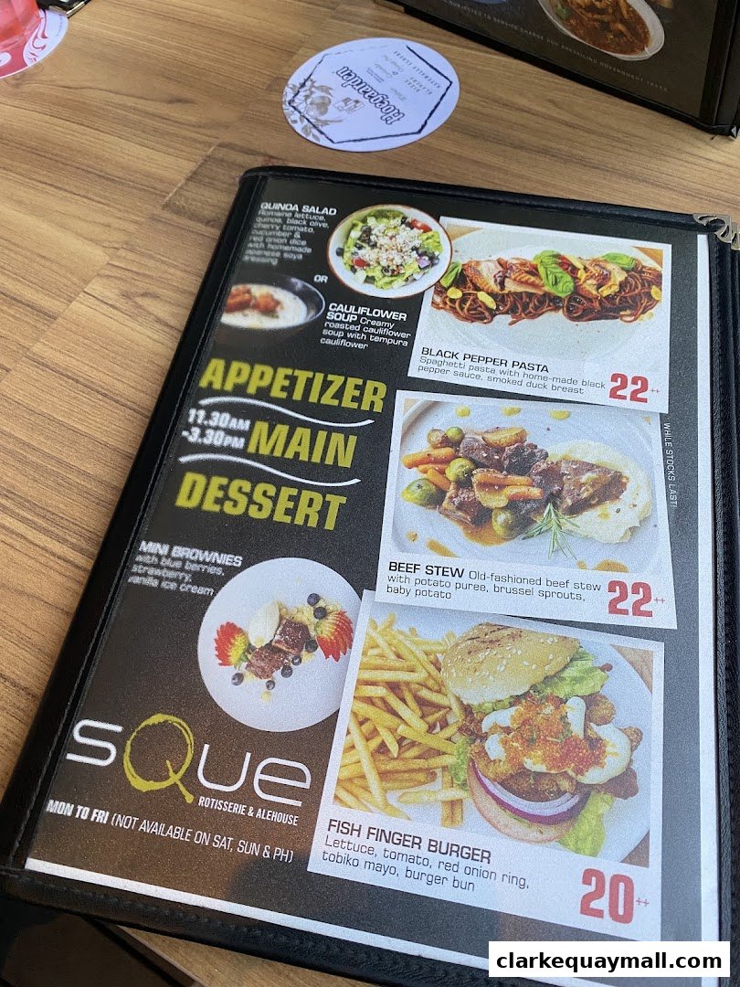A menu from SQUE Rotisserie & Alehouse featuring pasta, stew, and burgers.