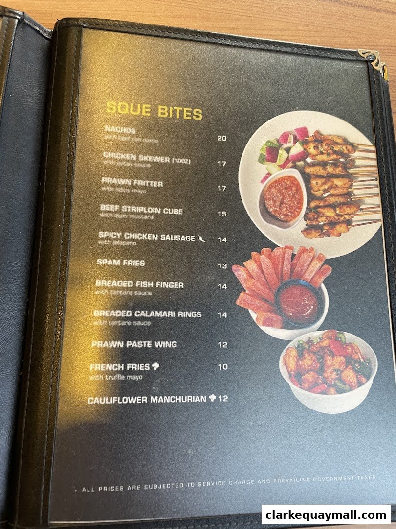 A menu page from SQUE Rotisserie & Alehouse featuring various appetizers and sides.