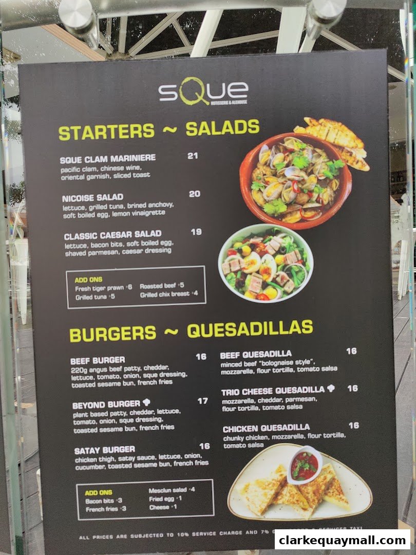 A menu board for SQUE Rotisserie & Alehouse, featuring starters, salads, burgers, and quesadillas.