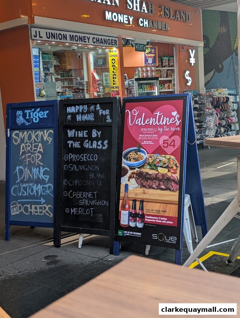 A street view of SQUE Rotisserie & Alehouse with promotional A-frame signs outside.