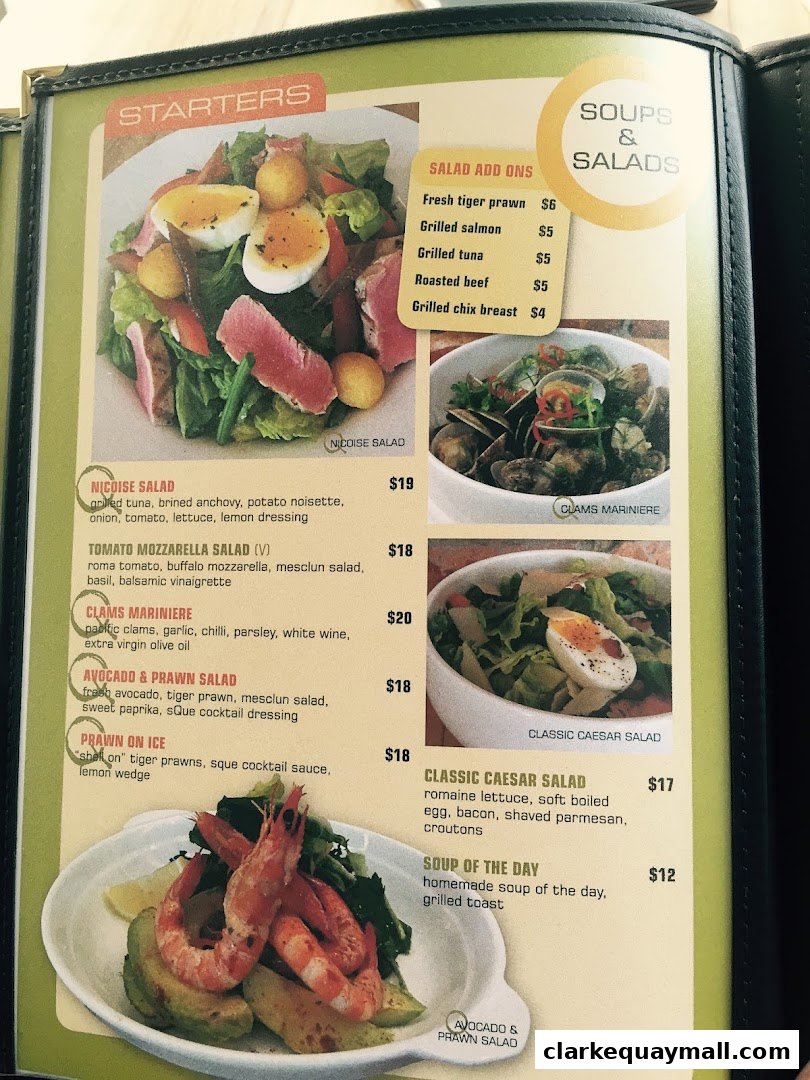 A menu from SQUE Rotisserie & Alehouse featuring starters, soups, and salads with enticing descriptions and prices.