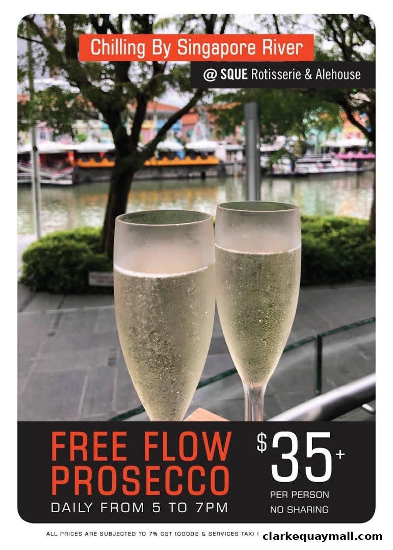 Two glasses of Prosecco with a view of the Singapore River and colorful buildings.