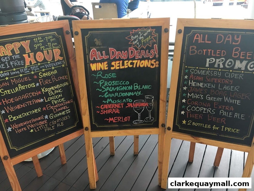 Three chalkboards display happy hour deals, wine selections, and bottled beer promotions.