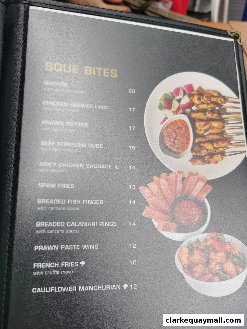 A menu page from SQUE Rotisserie & Alehouse featuring various appetizers and sides.