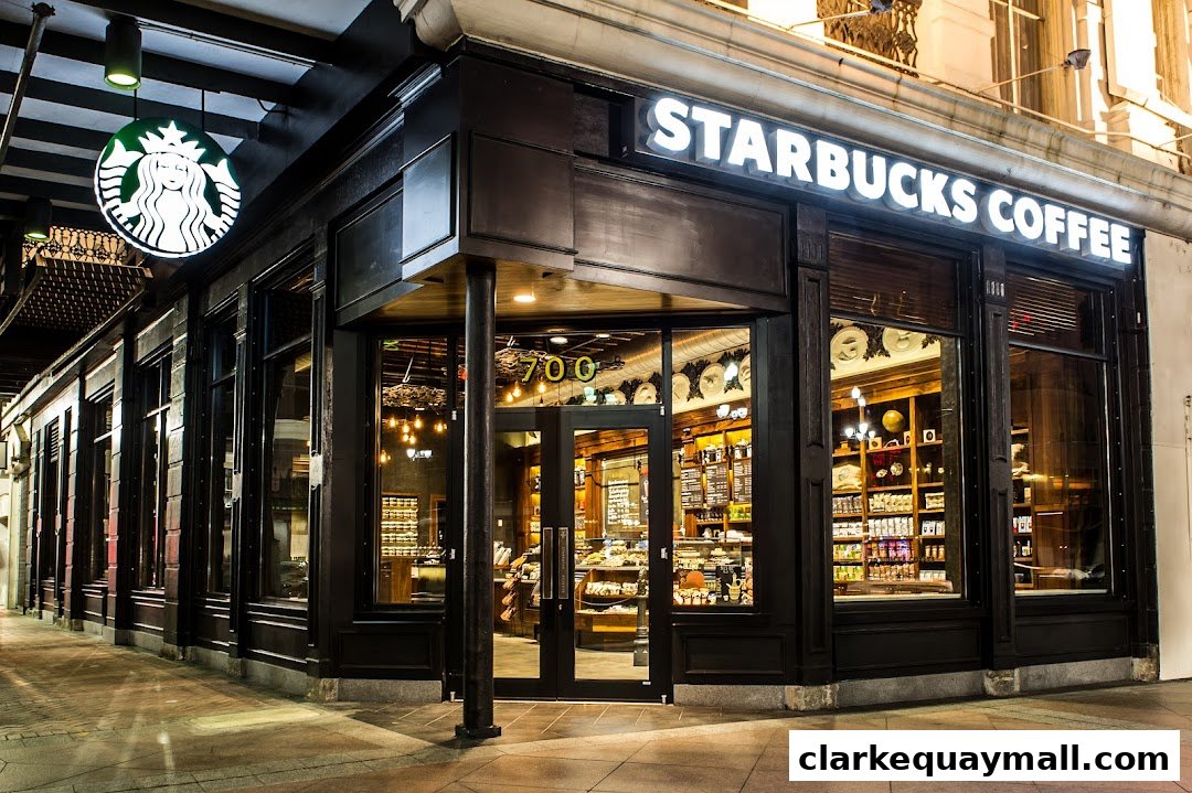 The exterior of a Starbucks Coffee shop at night, with illuminated signage and a welcoming entrance.