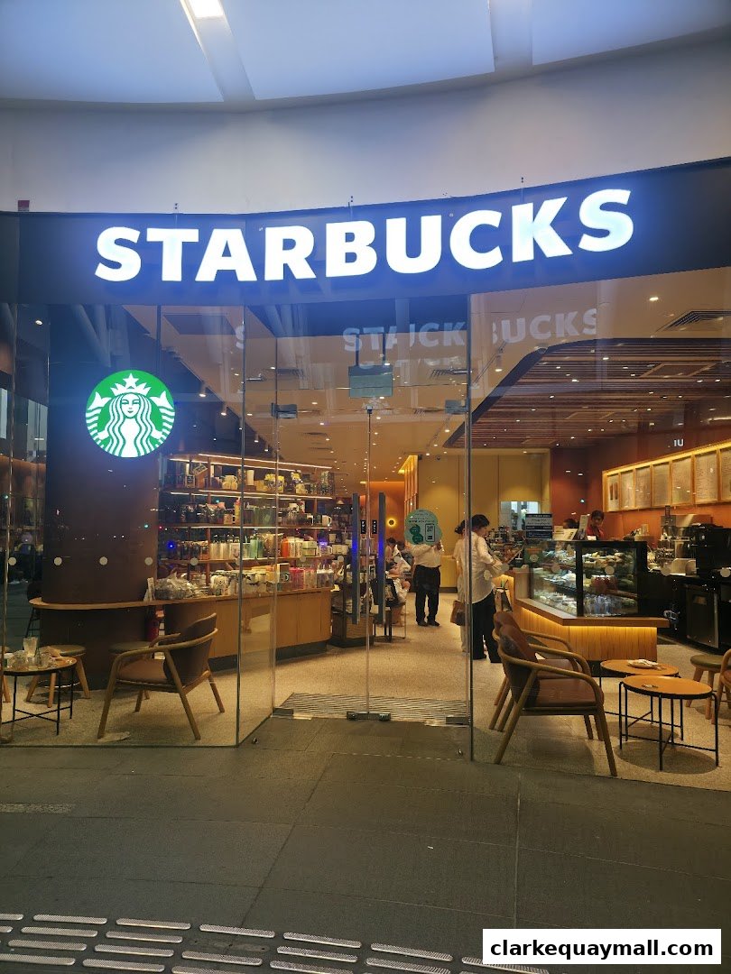 The inviting entrance of Starbucks The Central, showcasing its iconic logo and warm interior.