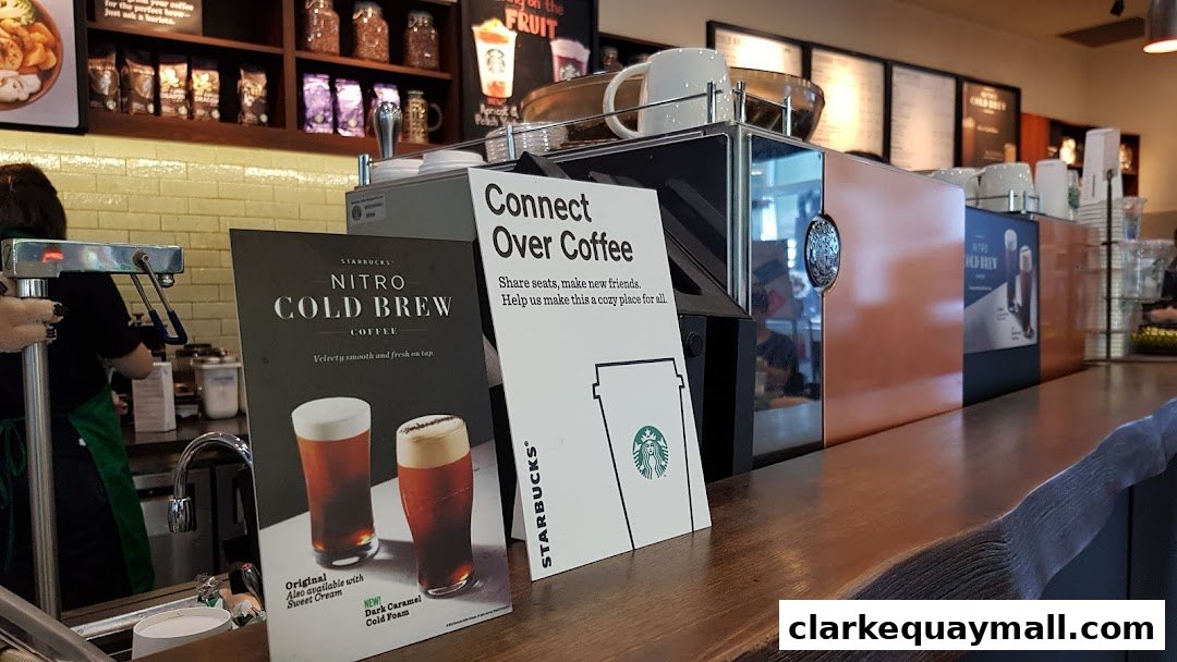 Starbucks counter with promotional signs for Nitro Cold Brew and a cozy atmosphere.