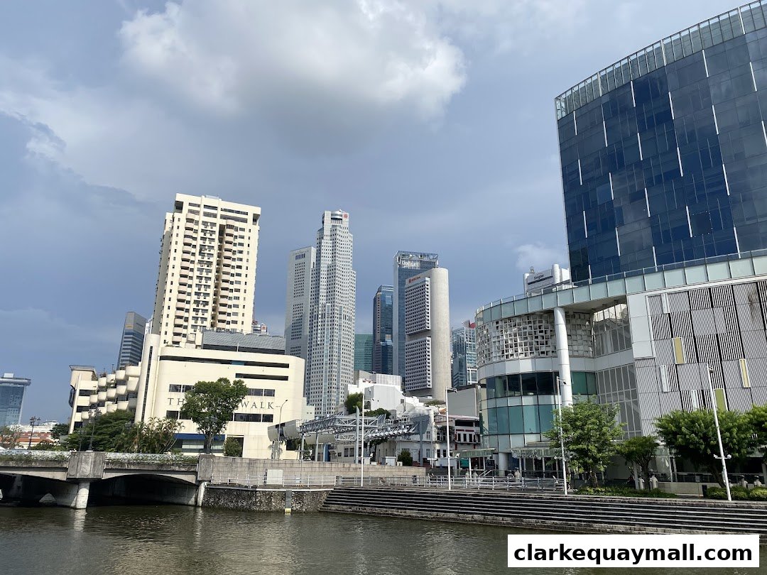A cityscape view of modern buildings and a river under a cloudy sky.