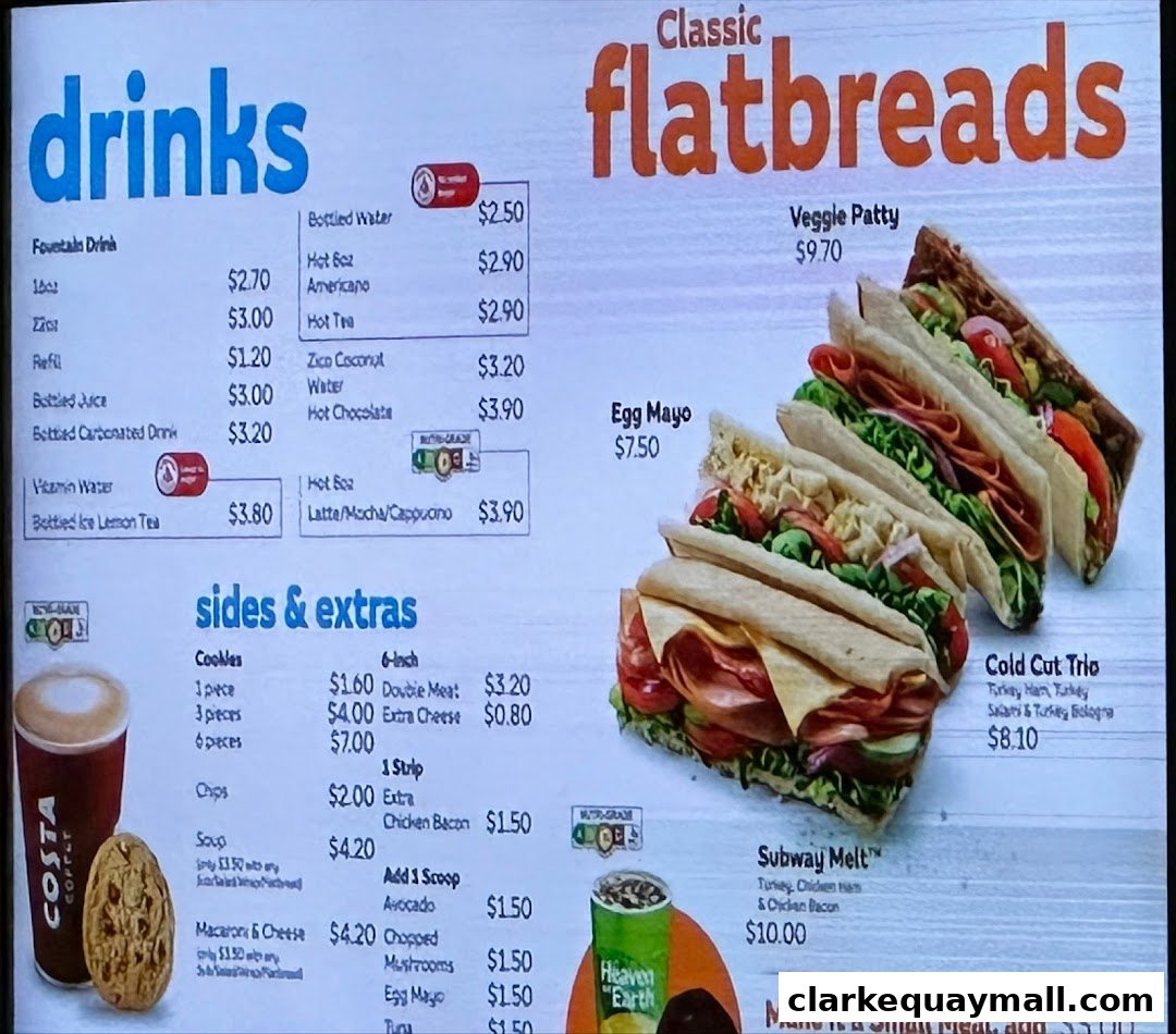 A menu board displaying drinks, flatbreads, sides, and extras with prices.