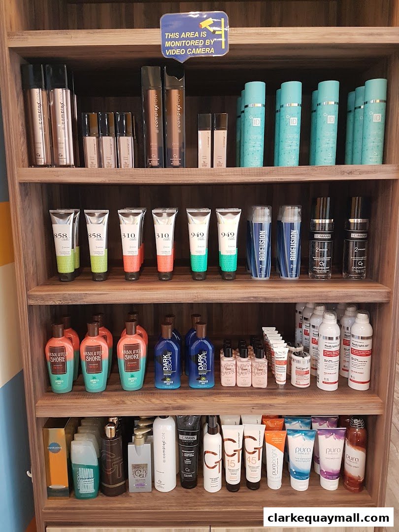 Shelves stocked with various tanning lotions, sprays, and skincare products.