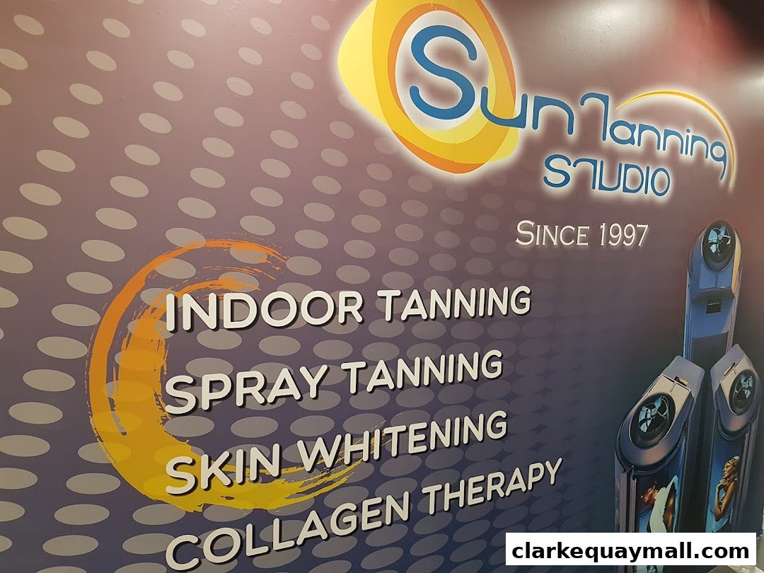 A wall graphic for Sun Tanning Studio, listing services like indoor tanning and spray tanning.