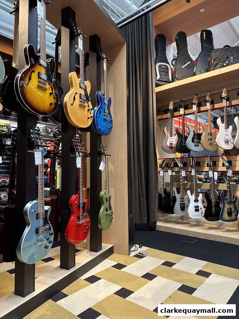 A wide selection of electric guitars displayed on stands and shelves in a music store.