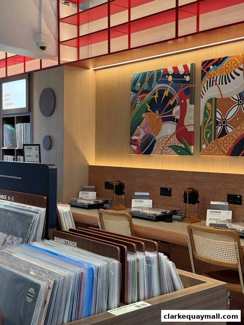 Interior of a vinyl record store with listening stations and rows of records.