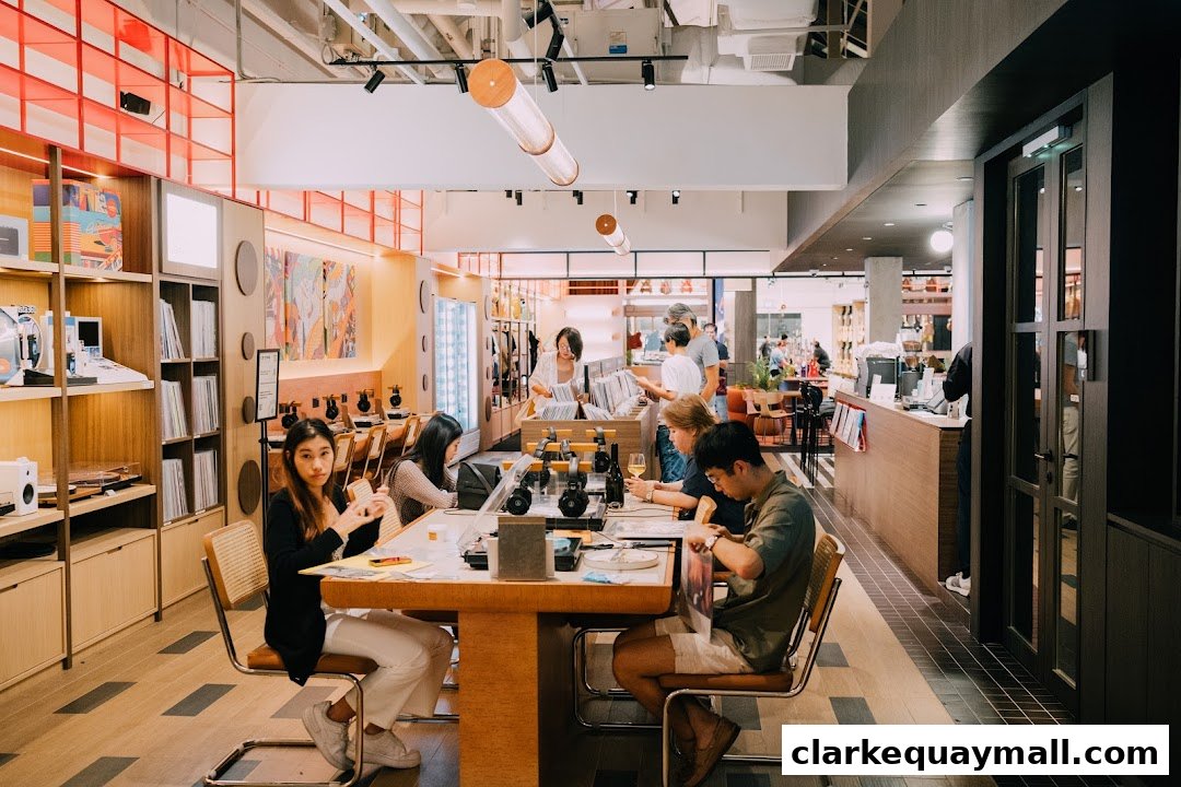 People browsing and sitting at tables in a modern music store with shelves of records and audio equipment.