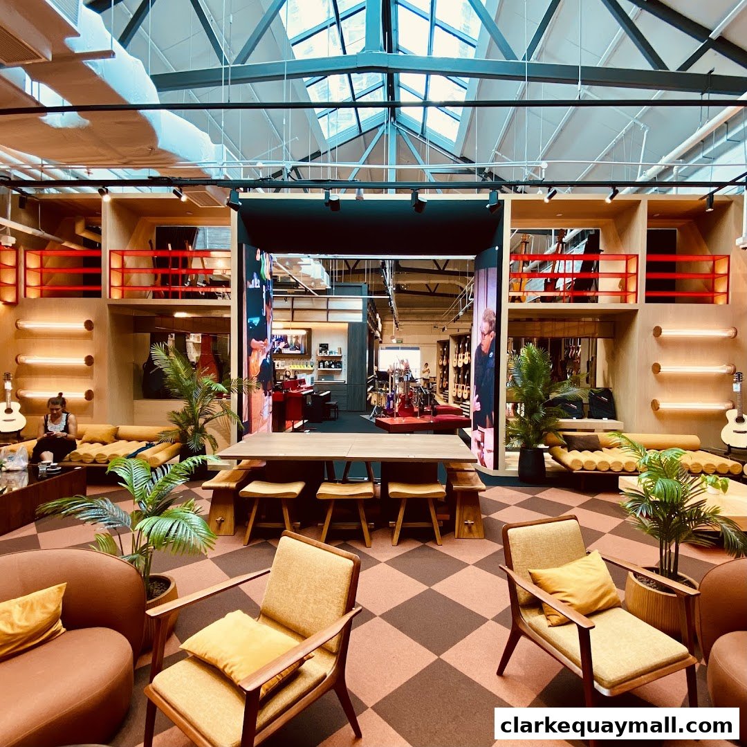 Interior of a modern music store with seating areas and musical instruments on display.