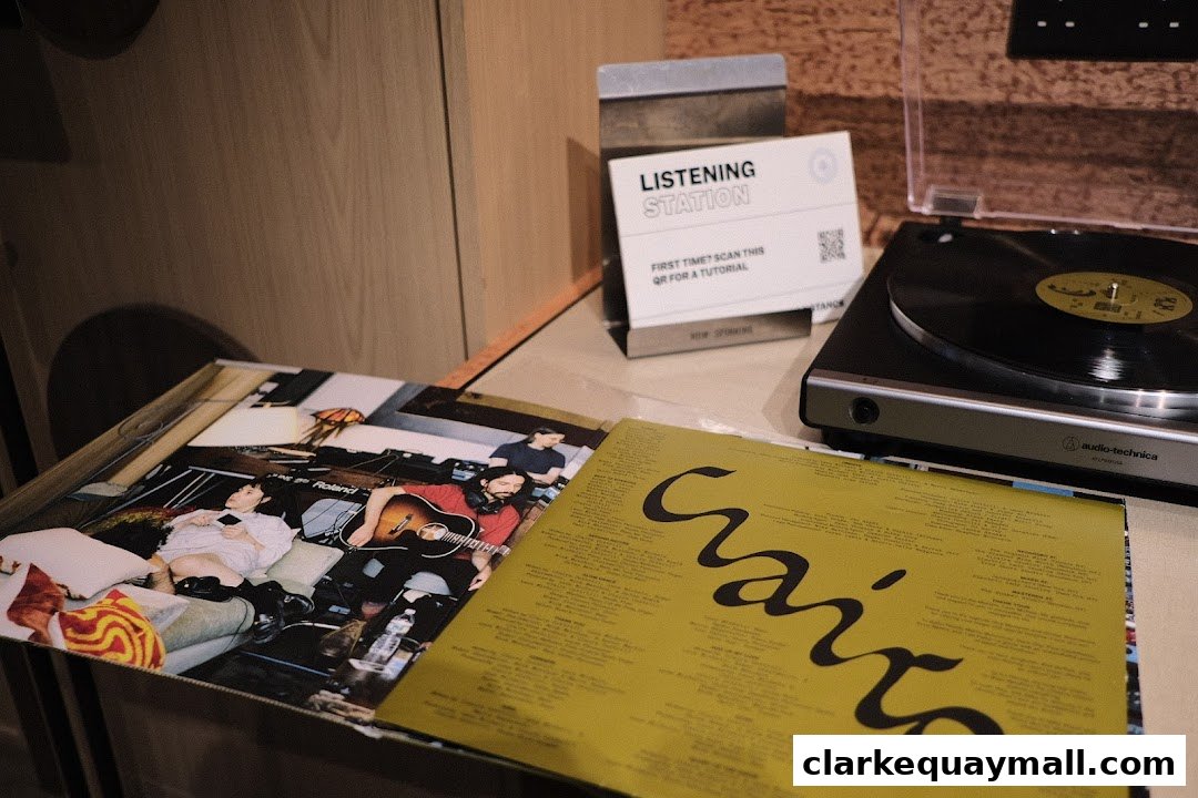 A listening station with vinyl records, a turntable, and a QR code for a tutorial.