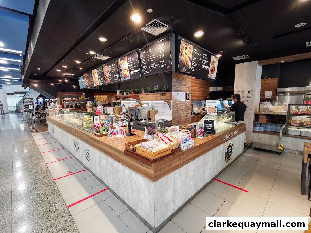 A wide shot of the Swissbake Cafe counter with food displays and menus overhead.