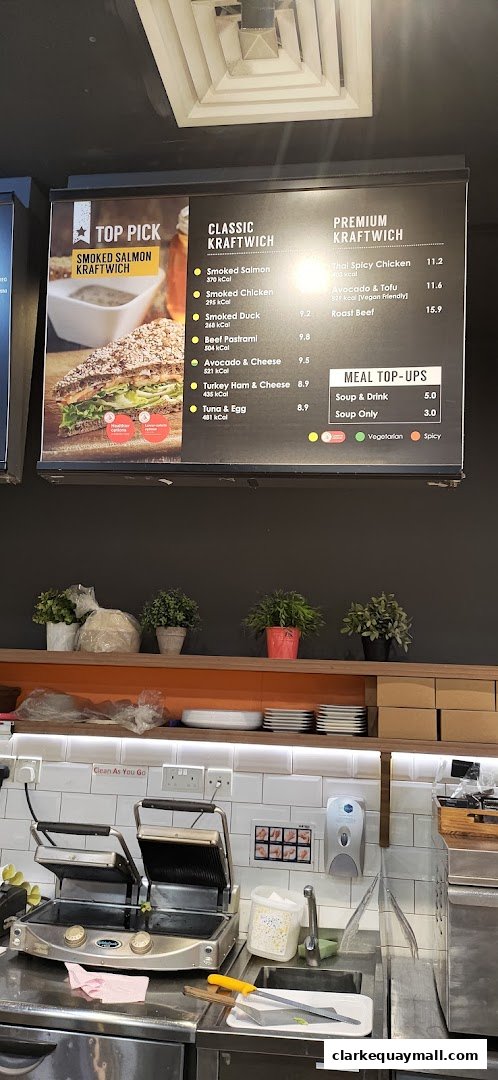 A menu board displaying classic and premium Kraftwiches, with a top pick of Smoked Salmon Kraftwich.