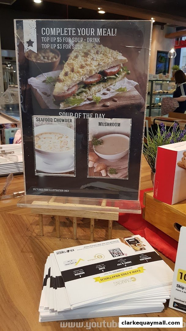 A promotional display for Swissbake Cafe featuring a sandwich and soup options.