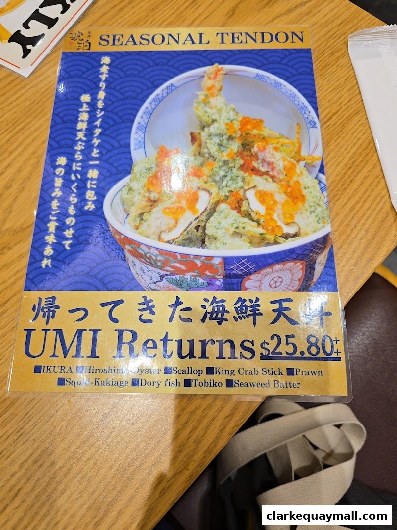 A menu featuring a seasonal tendon dish with seafood and ikura.