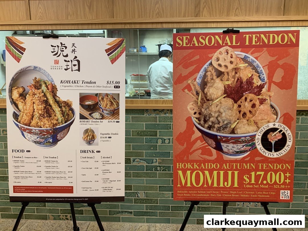 A display of two large posters showcasing Tendon Kohaku's signature dishes and seasonal offerings.